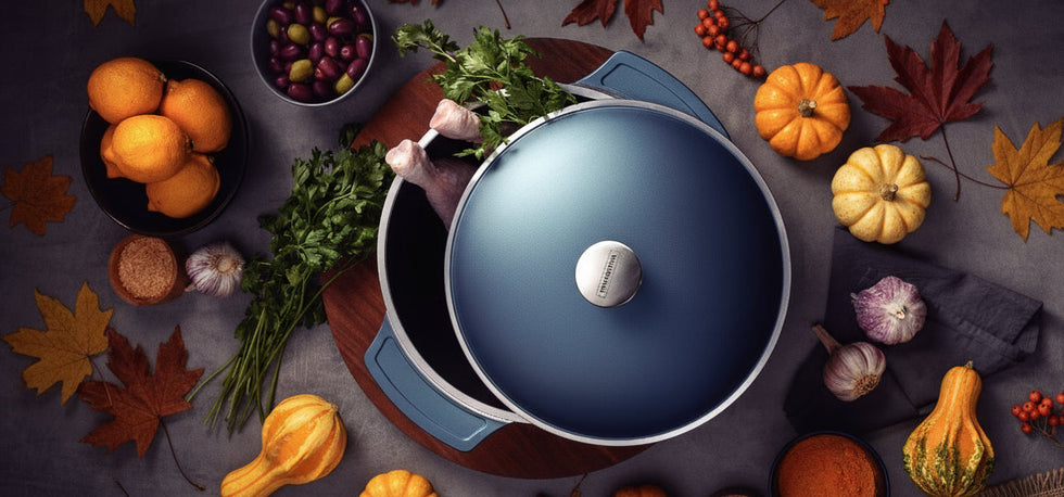 Blue pot with a lid on a wooden board surrounded by ingredients on a dark surface